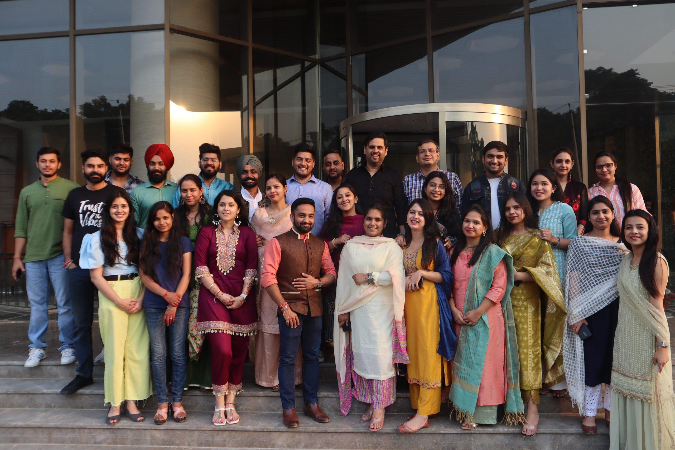 A group of people posing for a photo in front of a building.