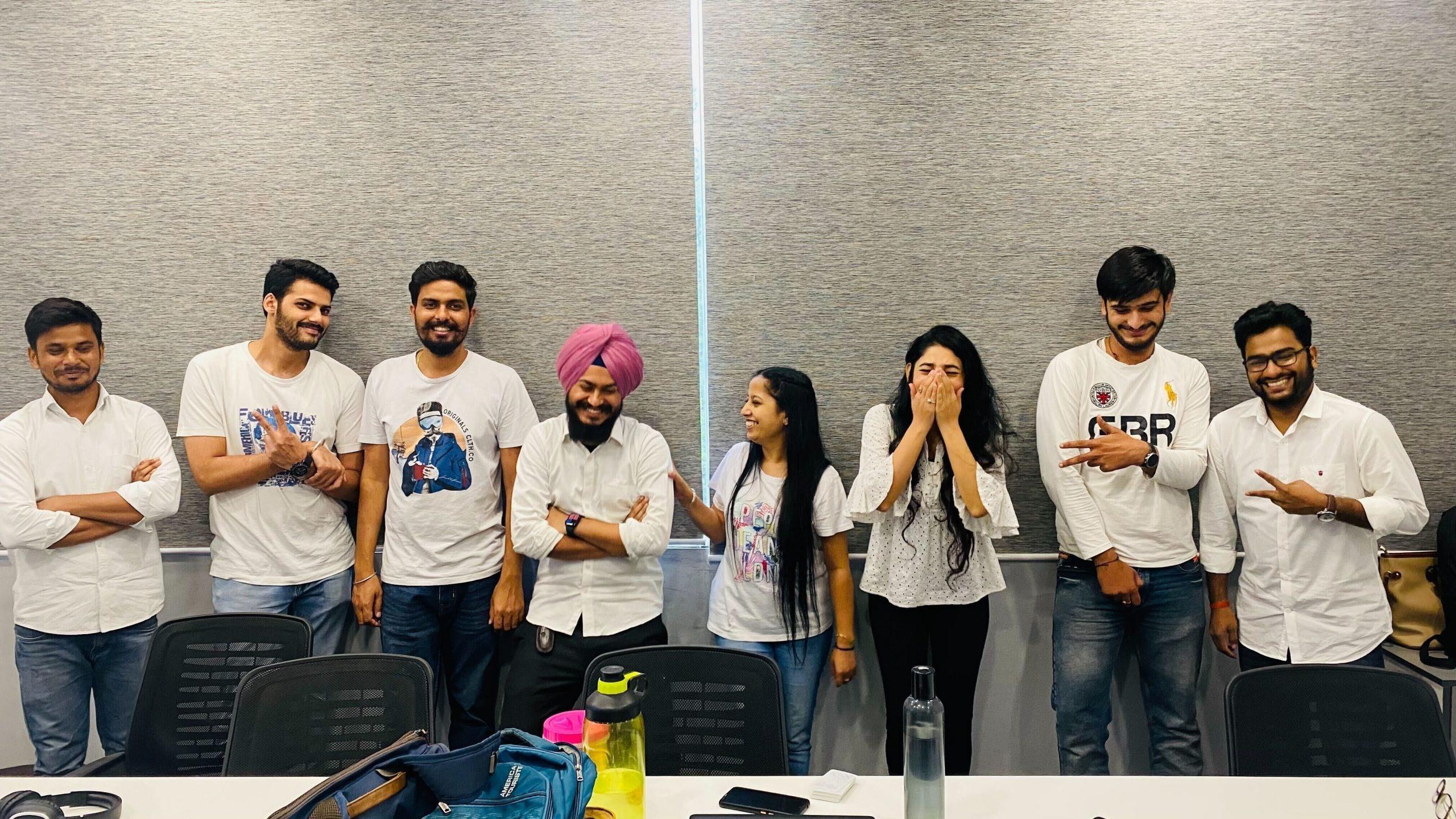 A group of people posing for a picture in a conference room.