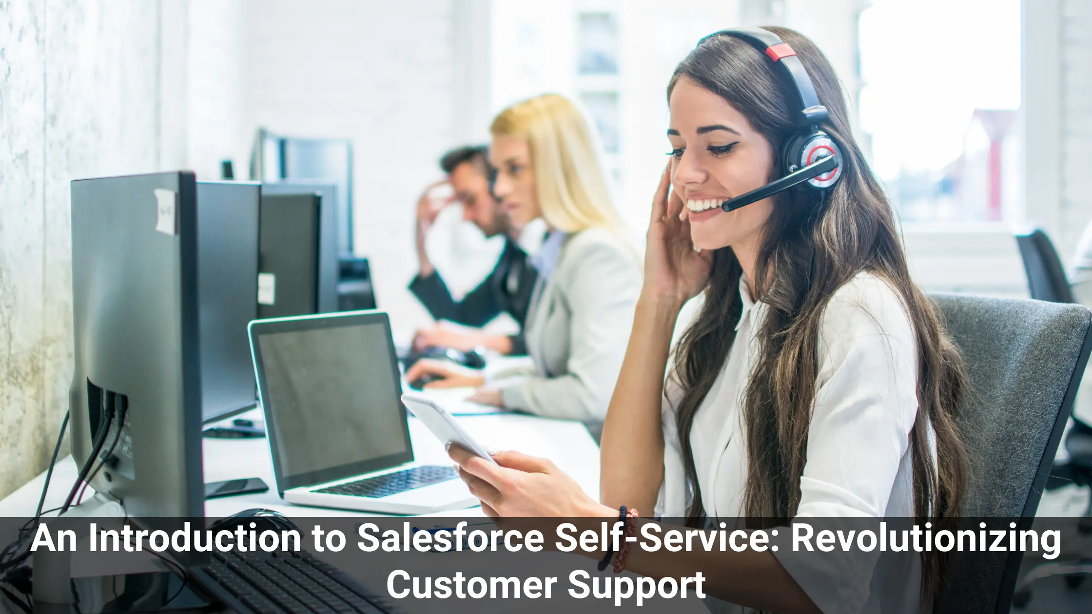 This image represent Salesforce Self-Service. A woman wearing a headset is sitting with a laptop and a mobile phone in her hand .