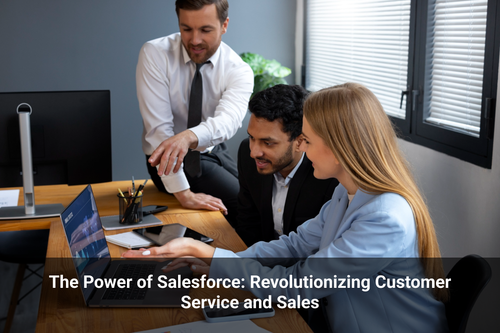 A woman and a man employees are sitting on a chair and one more man employee is sitting on a table and they are all looking at a laptop and discussing