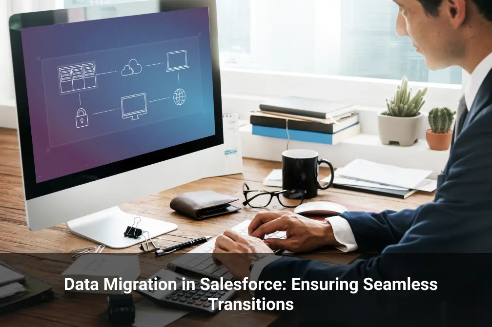 A person in a blue suit sitting at a desk with a computer representing Data Migration in Salesforce